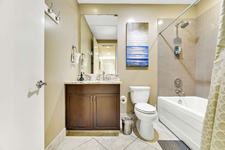 Guest bath with tub/shower combo.