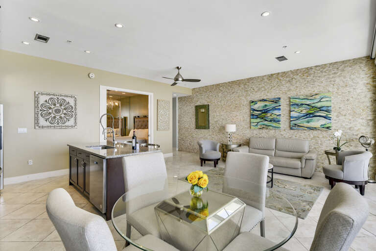 Large 200 sq-ft living area with sleeper sofa, indoor dining, and fully-equipped kitchen with island and granite countertops.  The indoor dining is perfect for bad weather.