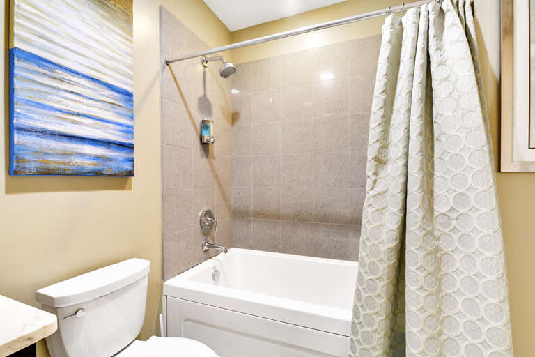 Guest bath with tub/shower combo.