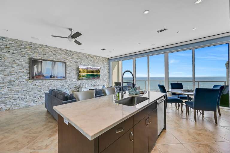 Dining area, kitchen island, sink, garbage disposal, onyx countertops, 75 inch Samsung smart TV