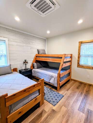 Twin over full bunk and extra twin in the guest bedroom.