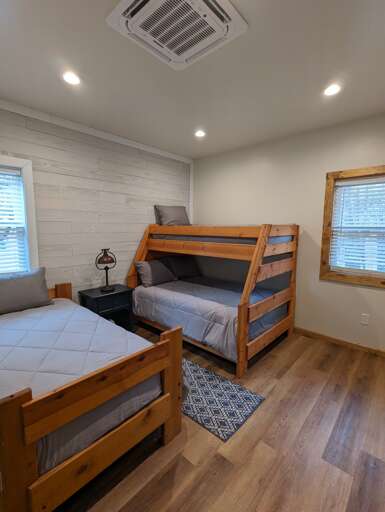 The beds in the guest bedroom sleep up to 4 with a twin over full bunk bed and another twin bed