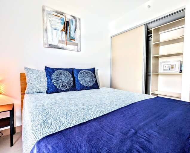 Guest Bedroom has safe, iron, and pool towels