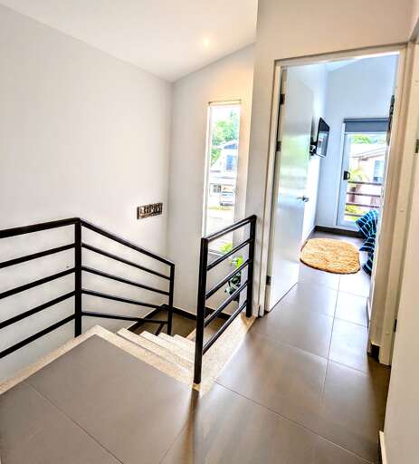 Stairs and hall of the upstairs(guest bathroom on the right)