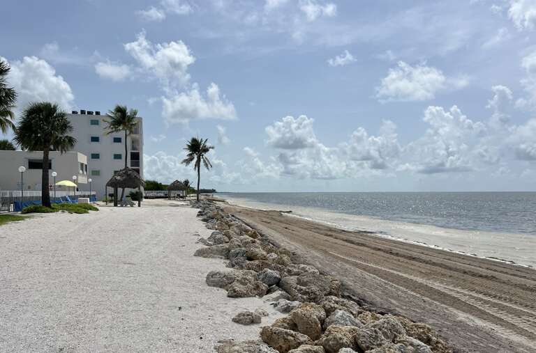 Enjoy a serene walk along the beach, mere steps from your luxurious condo.
