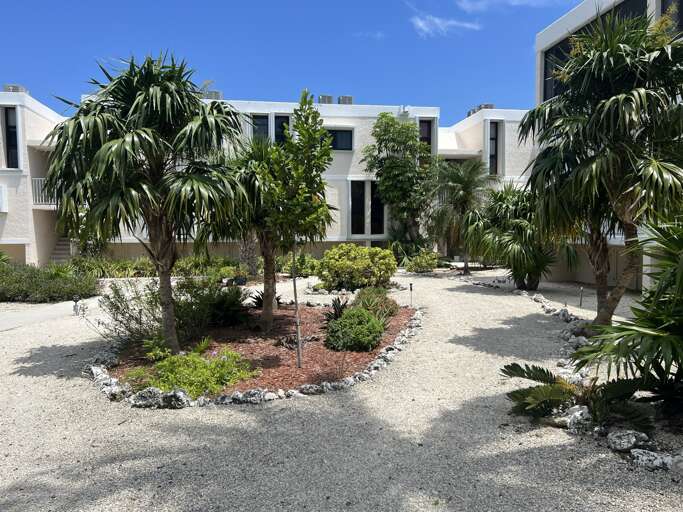 Stroll through the lush, tropical garden at the Royal Plum Club Condominiums