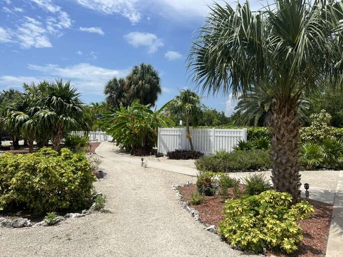 Stroll through the lush, tropical garden at the Royal Plum Club Condominiums