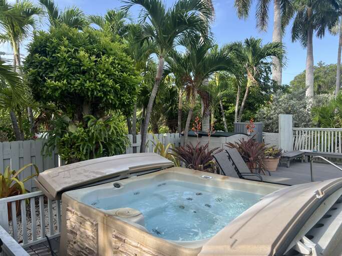 Unwind in the private hot tub, nestled among tropical greenery for a relaxing retreat Unwind in the private hot tub, nestled among tropical greenery for a relaxing retreat