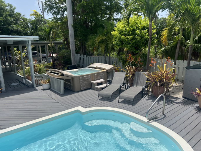 Dive into relaxation with your private pool and hot tub, surrounded by lush tropical greenery Dive into relaxation with your private pool and hot tub, surrounded by lush tropical greenery