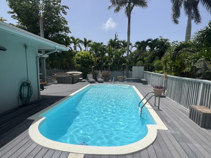 Dive into relaxation with your private pool and hot tub, surrounded by lush tropical greenery Dive into relaxation with your private pool and hot tub, surrounded by lush tropical greenery
