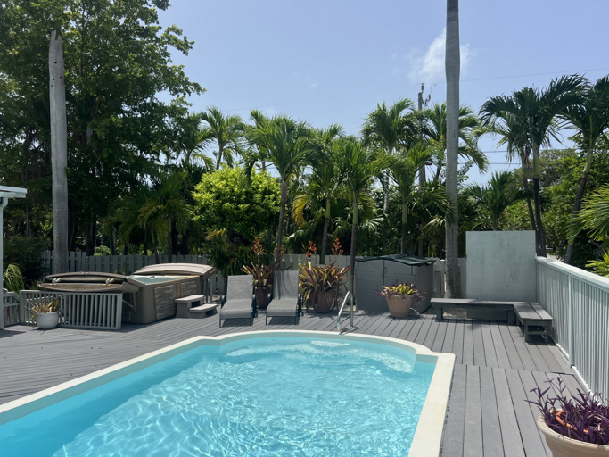 Dive into relaxation with your private pool and hot tub, surrounded by lush tropical greenery