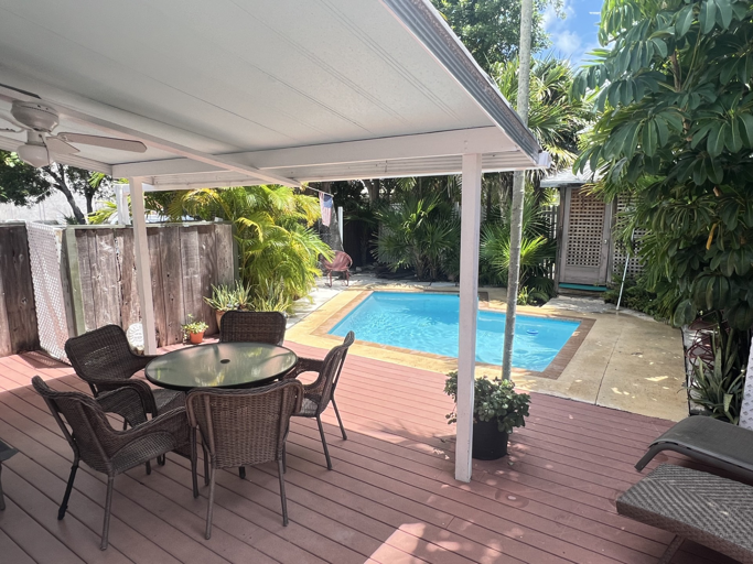 Unwind in your private tropical oasis, where lush greenery surrounds a serene pool. Sip your morning coffee or enjoy an al fresco meal on the spacious deck