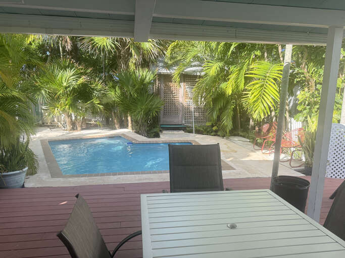 Unwind in your private tropical oasis, where lush greenery surrounds a serene pool. Sip your morning coffee or enjoy an al fresco meal on the spacious deck.
