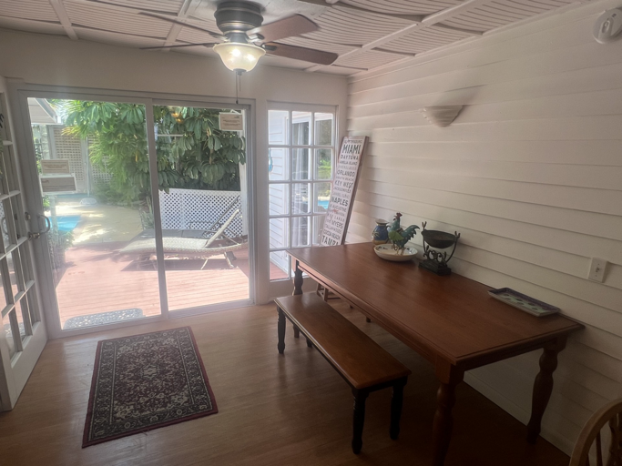 Dining area with access to the deck and pool area. Perfect for enjoying meals with a view.