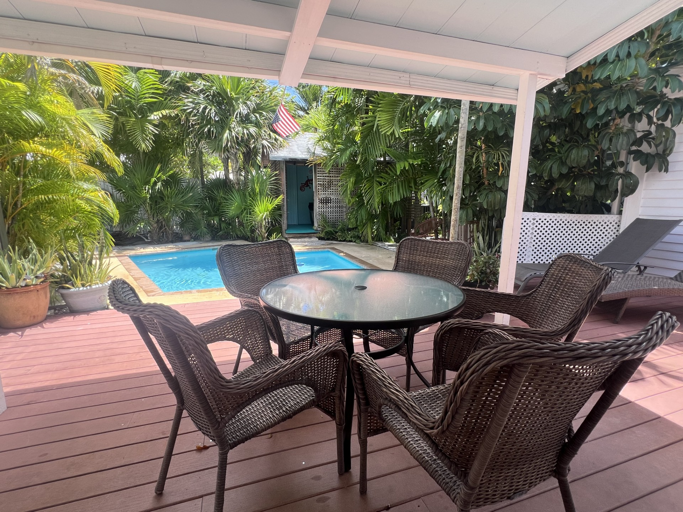 Unwind in your private tropical oasis, where lush greenery surrounds a serene pool. Sip your morning coffee or enjoy an al fresco meal on the spacious deck