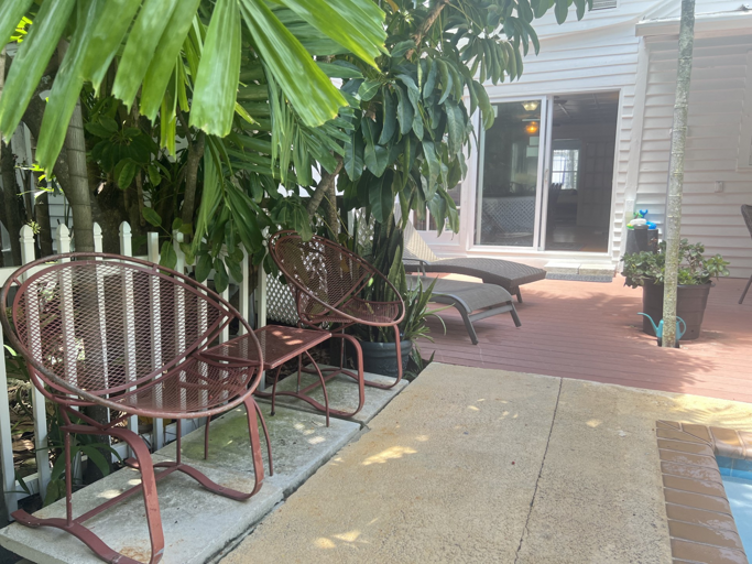 Unwind in your private tropical oasis, where lush greenery surrounds a serene pool. Sip your morning coffee or enjoy an al fresco meal on the spacious deck