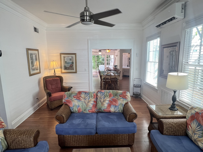 Enjoy the bright and airy feel of this living room, with plenty of space to relax. It connects to the dining area, making it perfect for socializing and hanging out with friends and family.