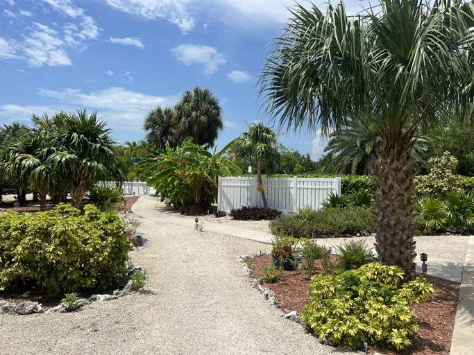 Stroll through the lush, tropical garden at the Royal Plum Club Condominiums