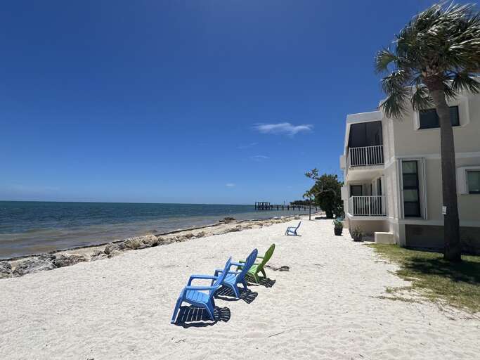 Enjoy a serene walk along the beach, mere steps from your  condo.
