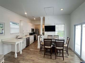 Bright and open kitchen and dining area, perfect for cooking meals and gathering around the table. Enjoy all the comforts of home with plenty of space to dine and relax.