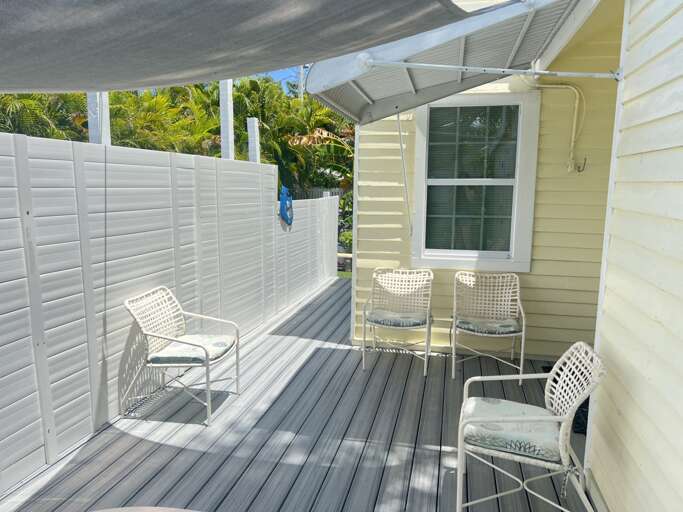 Perfect for morning coffee or an evening chat, this private side deck is just steps away from the small pool, offering a cozy spot to relax and unwind.