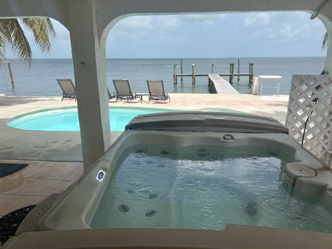 Private hot tub with stunning Gulf views, just steps away from the pool and private dock