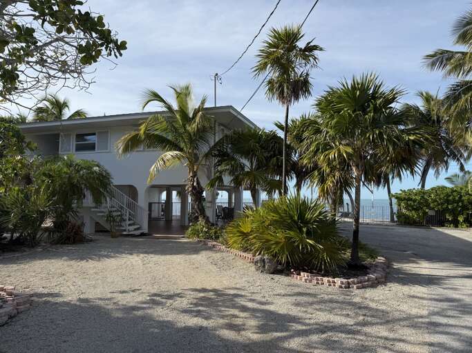 Charming oceanfront house with lush tropical landscaping