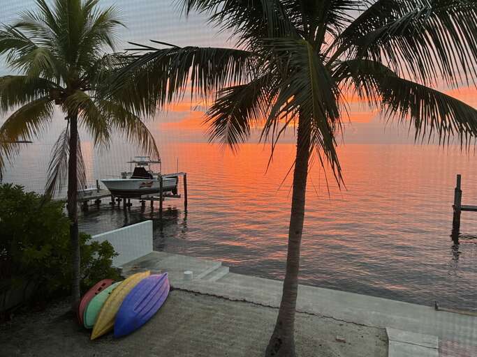 View Breathtaking Sunsets from the Screened-In Porch