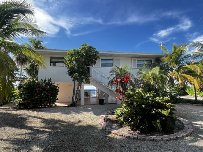 Charming oceanfront house with lush tropical landscaping