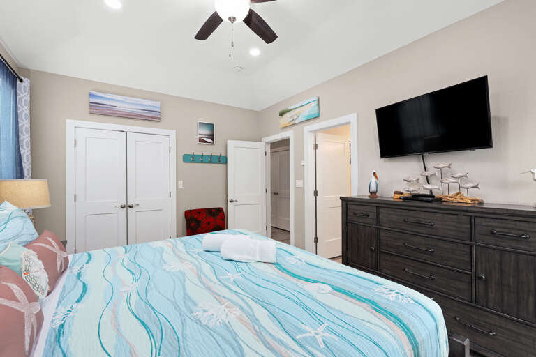 Comfortable, well appointed bedroom, with streaming TV. Coastal colors fill the room.