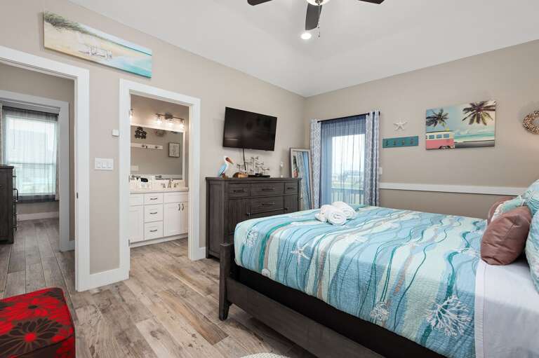 Comfortable, well appointed bedroom, with streaming TV. Coastal colors fill the room.