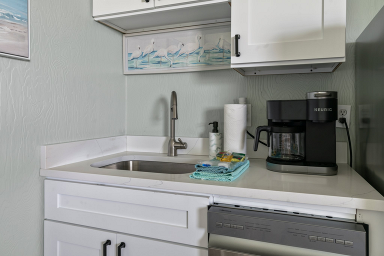Compact Kitchen Corner With Sink, Dishwasher, And Coffee Maker