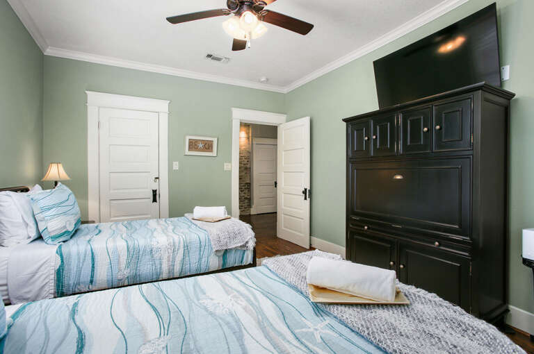 2 twin beds in this upstairs bedroom with streaming TV