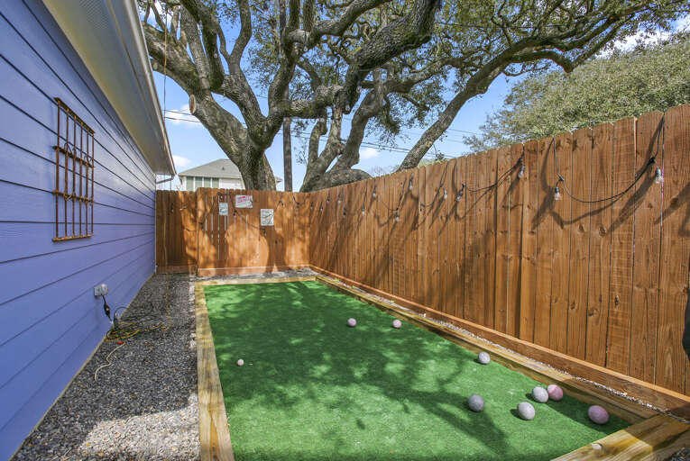 Enjoy [layomg Bocce Ball under a gorgeous big oak tree lined with party lights!