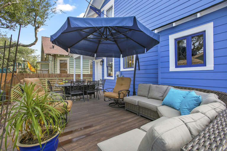 Great, private backyard area, with comfy furnishings, deck, unbrellas, and even a Bocce Ball court!