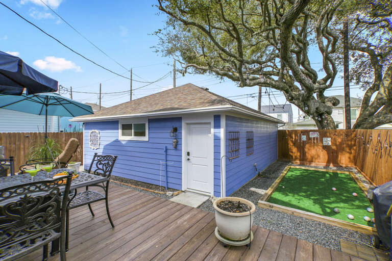 Great, private backyard area, with comfy furnishings, deck, unbrellas, and even a Bocce Ball court!