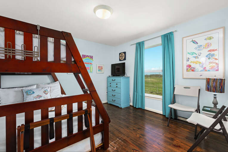 Bunk room with twin over full bunkbed and streaming TV.
