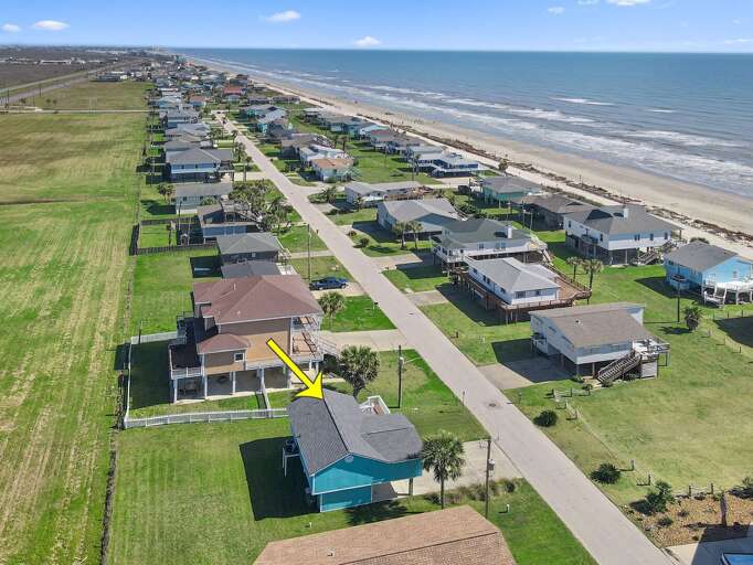 Take a left in front of house,  then a right to the beach.  You can see the path in this photo. It is about four houses down.