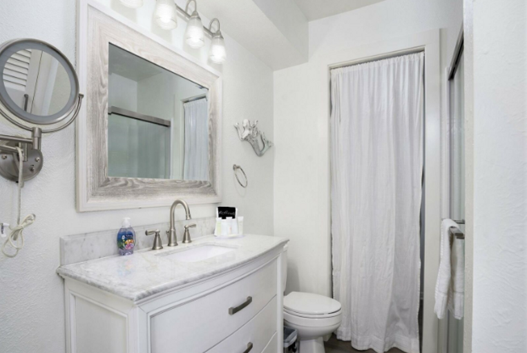 Master bathroom with shower, and entry to laundry room.