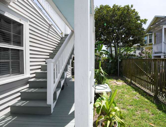 Yard, and stairs to upper balcony.