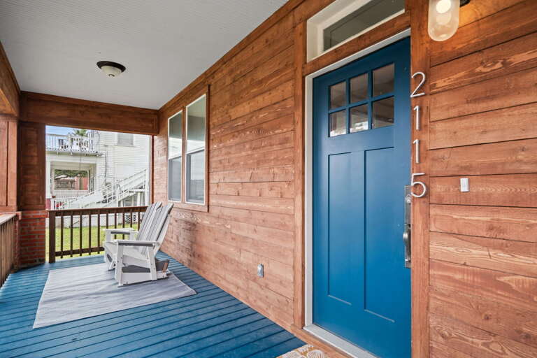 Blue Door And Wooden Walls On A Breezy Balcony