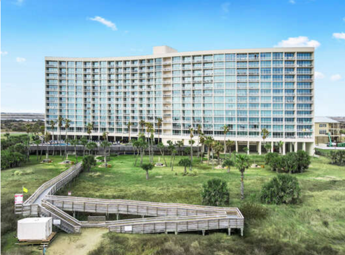 Convenient walk bridge to and from the beach.  Photo at beach looking back at the Galvestonian.