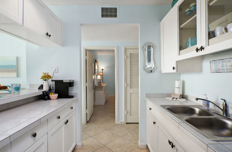 In kitchen, looking across to bedroom.