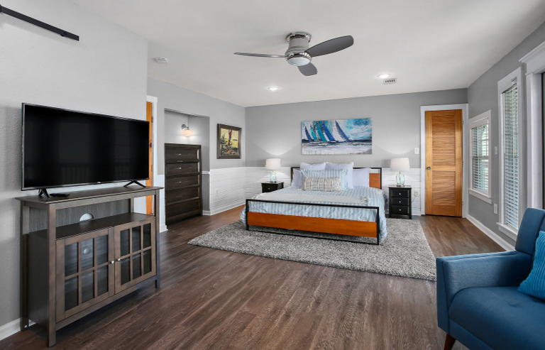 Lovely master with streaming TV,  sitting area, and beautiful, and deck with waterfront view