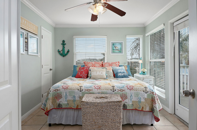 Master bedroom with king size bed, Smart TV, and en-suite bath that opens to the balcony.   Enjoy pool and ocean views!