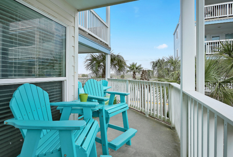 Sturdy, colorful patio furniture surrounded by palms