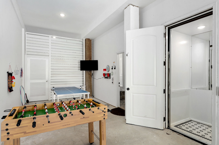 Game room, showing elevator, foosball table ping pong table, and streaming TV. Game room, showing elevator, foosball table ping pong table, and streaming TV.
