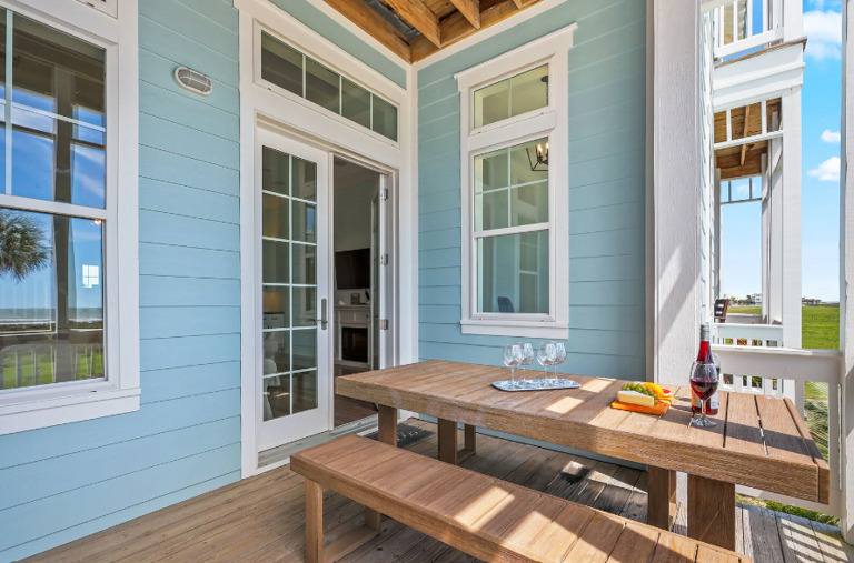 Outdoor dining table looking back towards living area, and office space to the right. Outdoor dining table looking back towards living area, and office space to the right.