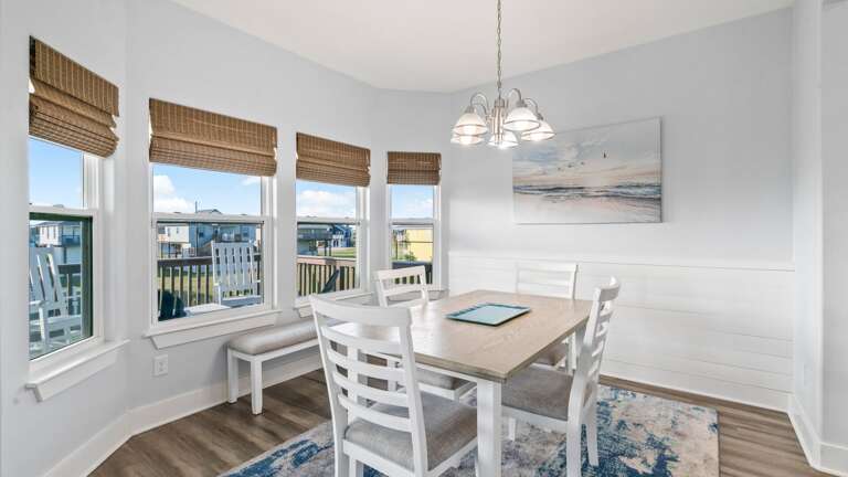 Large windows and great views surrounding the dining room.