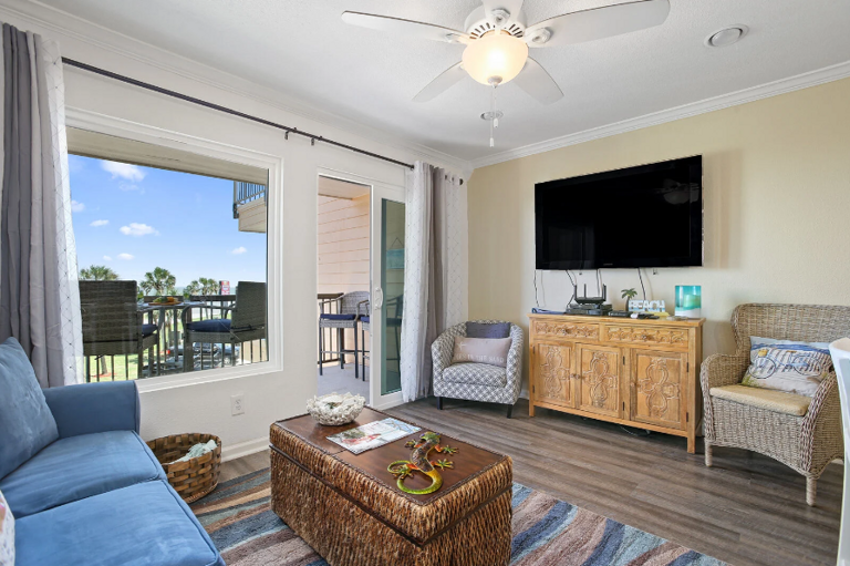 Comfy Living room with sleeper sofa, streaming TV, big windows, and large private balcony.